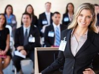 Businesswoman Delivering Presentation At Conference